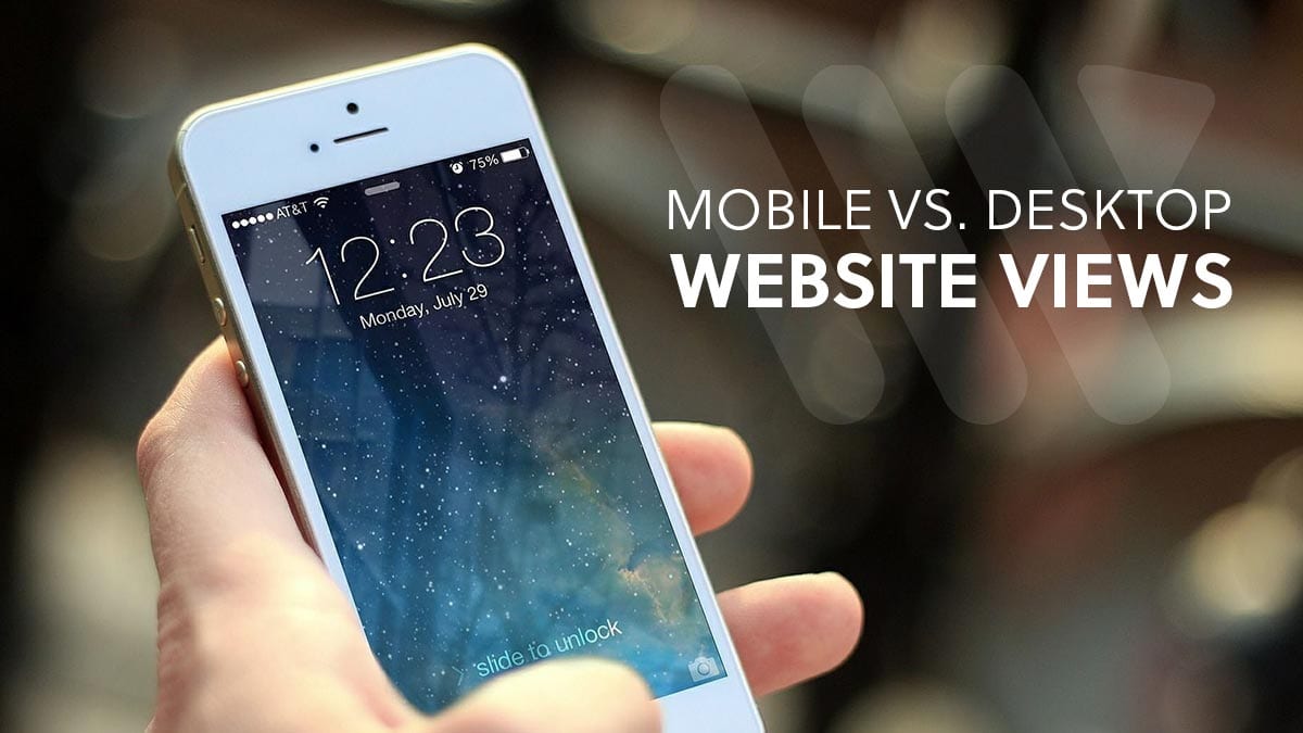 Hand holding mobile phone with text saying "Mobile vs Desktop website views"