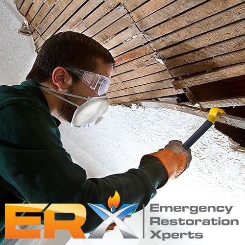 Emergency Restoration Xperts logo with image of worker removing damaged materials from a home