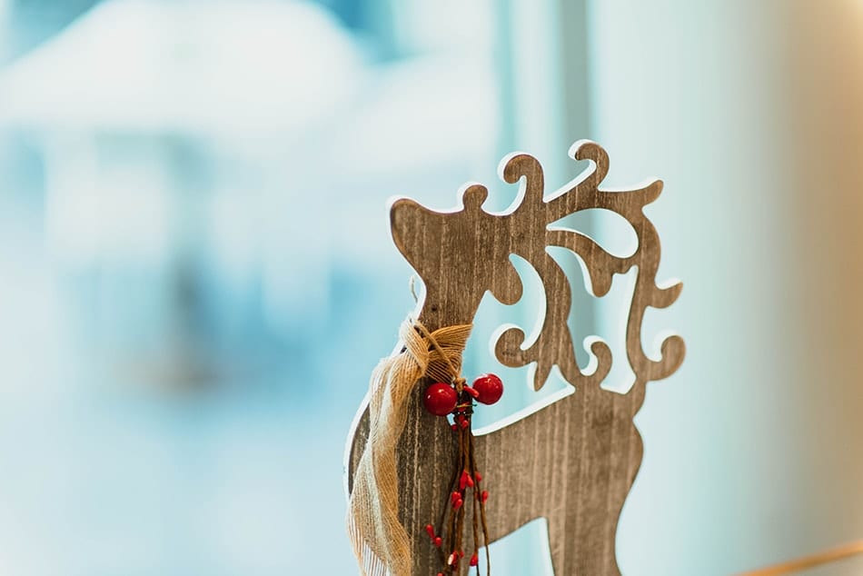 Wooden reindeer cutout with festive decorations